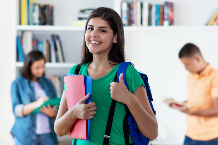 Successful,Hispanic,Female,Student,With,Group,Of,Young,Adults,At